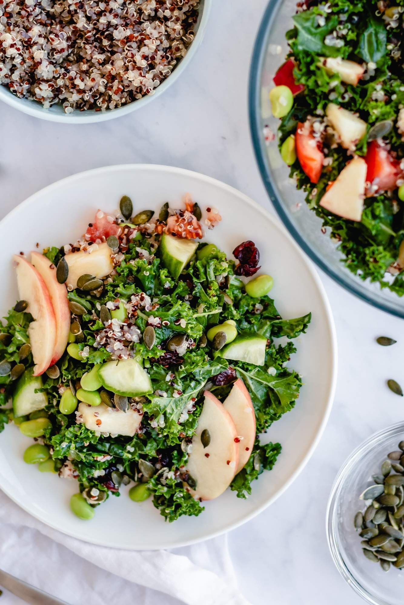 Quinoa and kale salad with honey lime dressing, apples, cooked quinoa, edamame, and dried cranberries.