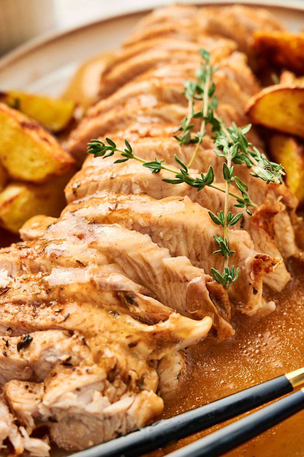 Pressure cooked turkey breast tenderloin sliced and served with gravy and fresh thyme.