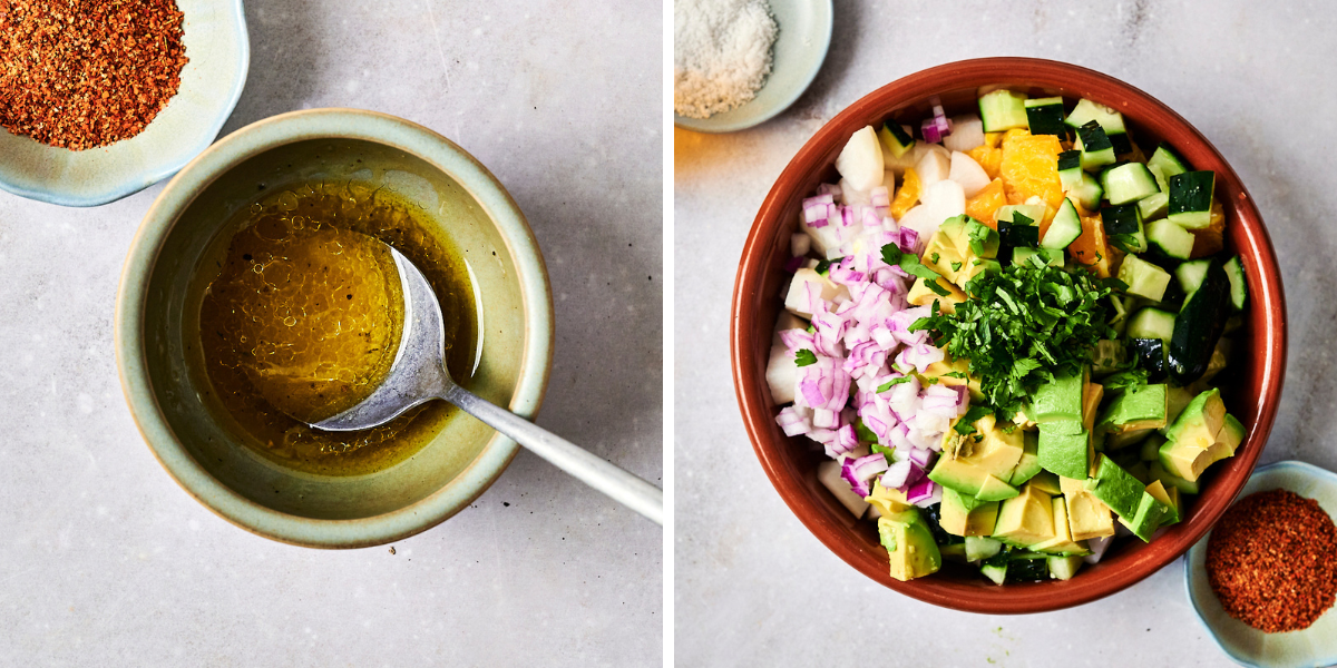 A bowl with olive oil and a spoon, beside a dish filled with chopped avocado, cucumber, onion, and spices on a marble surface.