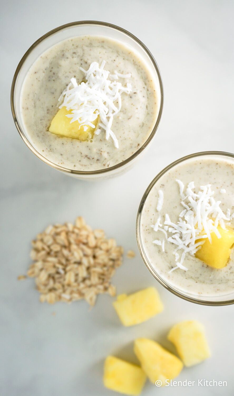 Oatmeal smoothie with pinapple and chia seeds on a marble background.