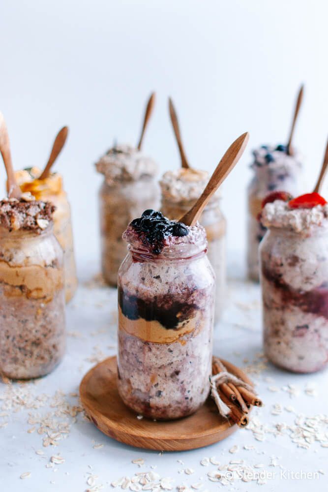 Overnight oatmeal with peanut butter and jelly layers with other flavors in the background. 
