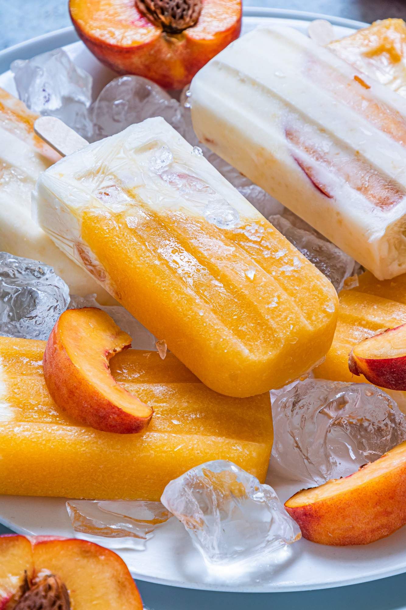 Frozen peach popsicles with fresh pureed peaches, Greek yogurt, and honey frozen into layered popsicles.