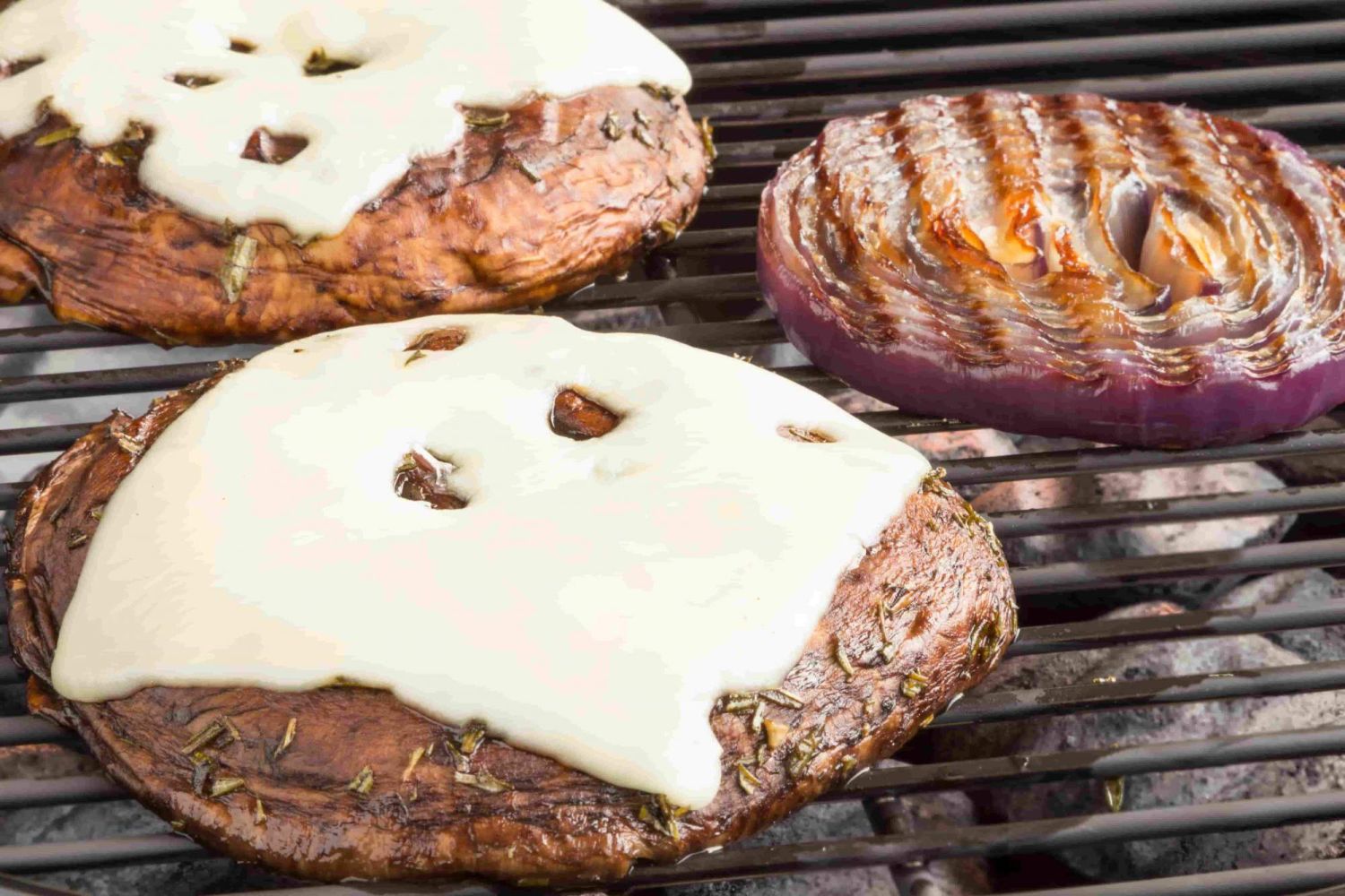 Portobello mushroom burger on the grill  wit melted Swiss cheese.