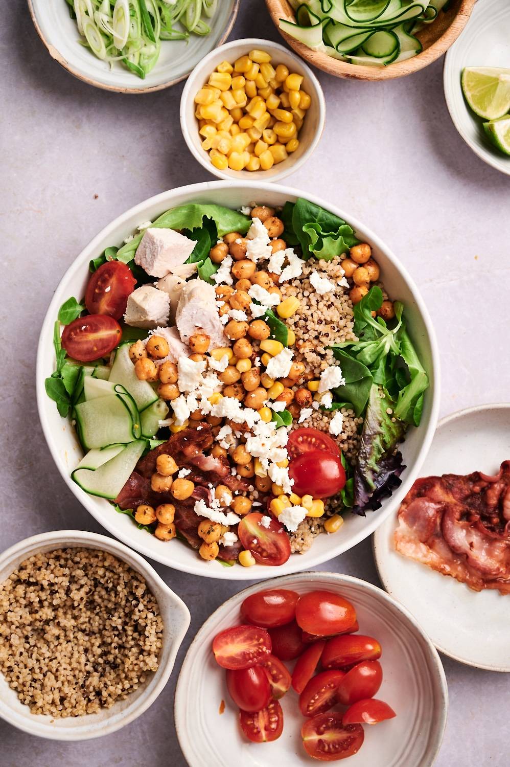 Protein salad bowl with chicken, turkey bacon, quinoa, veggies, and goat cheese.