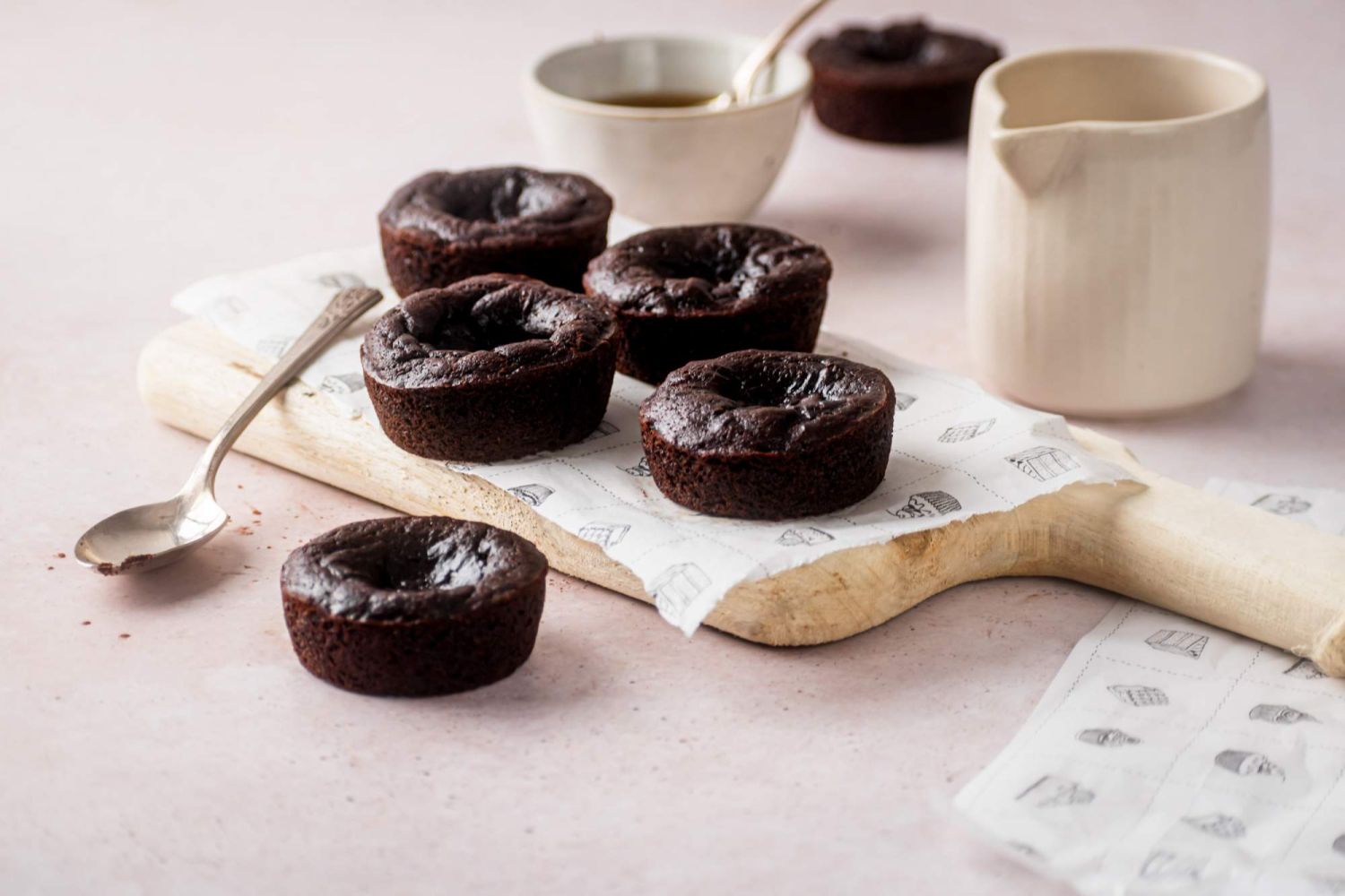 Fudgy flourless pumpkin brownies baked into muffins with coffee and maple syrup on the side.