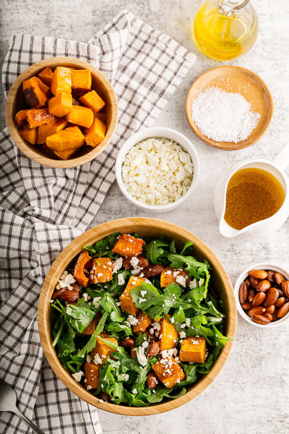 Butternut squash salad with roasted squash served with almonds, feta, and arugula with dressing on the side.