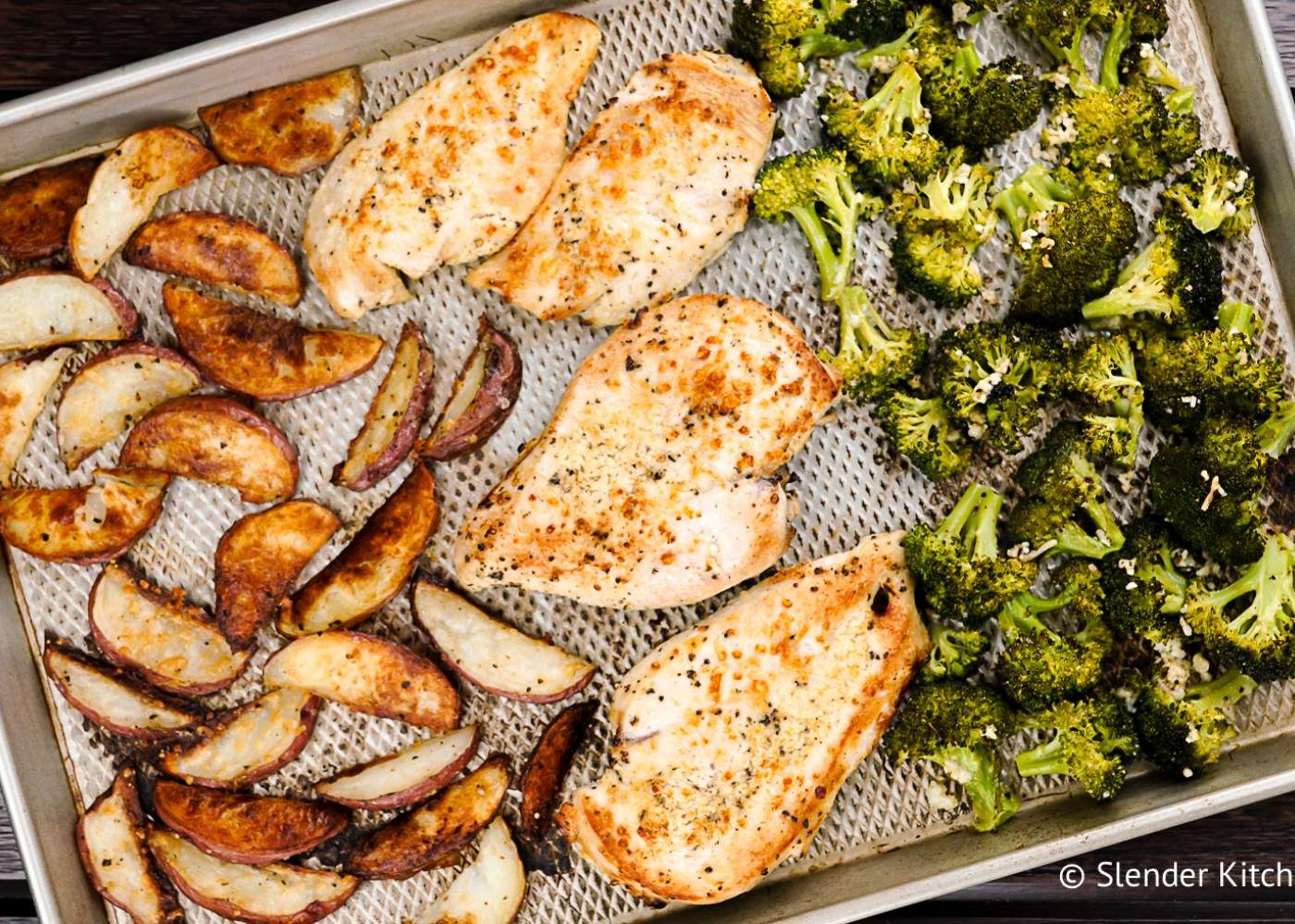 Roasted Chicken and potatoes with broccoli on a sheet pan.