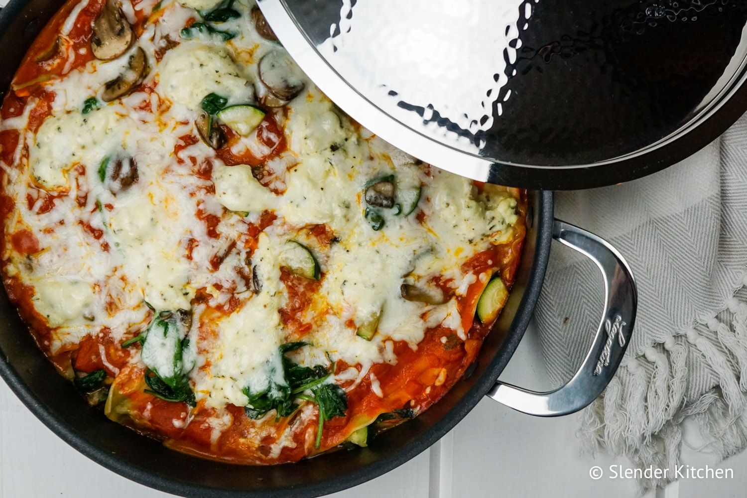 Easy stovetop lasagna made with vegetables, marinara sauce, ricotta cheese, and melted mozzarella cheese in a skilleyt.