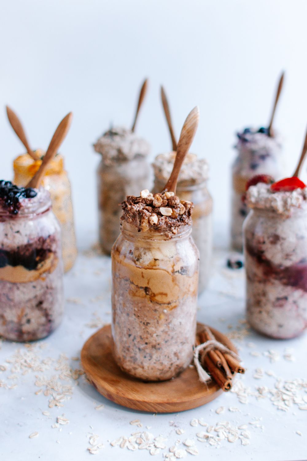 Peanut butter chocolate overnight oats in a glass jar with other flavors in the background.