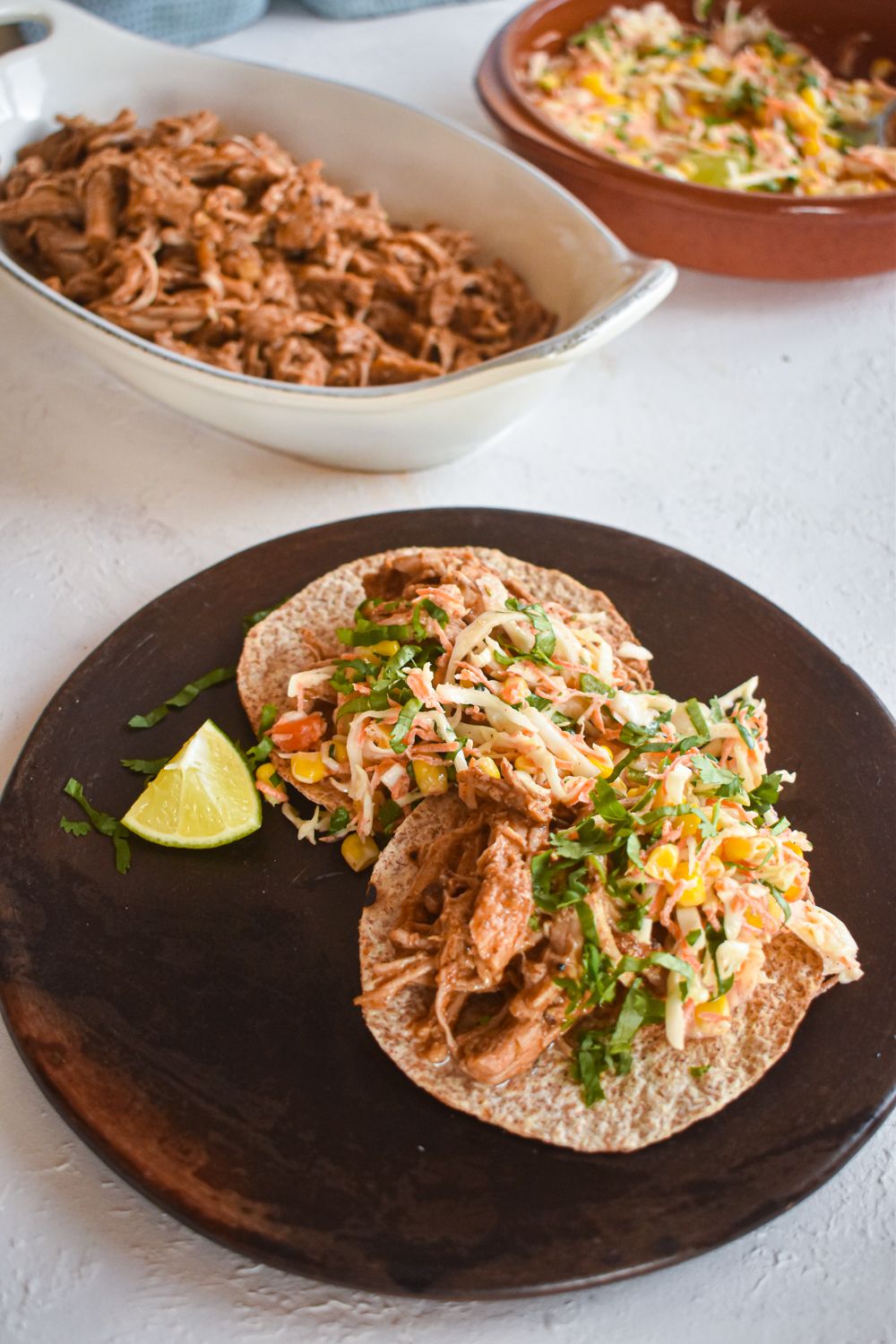 Chorizo spiced pulled pork on a toasted corn tortilla with corn slaw.