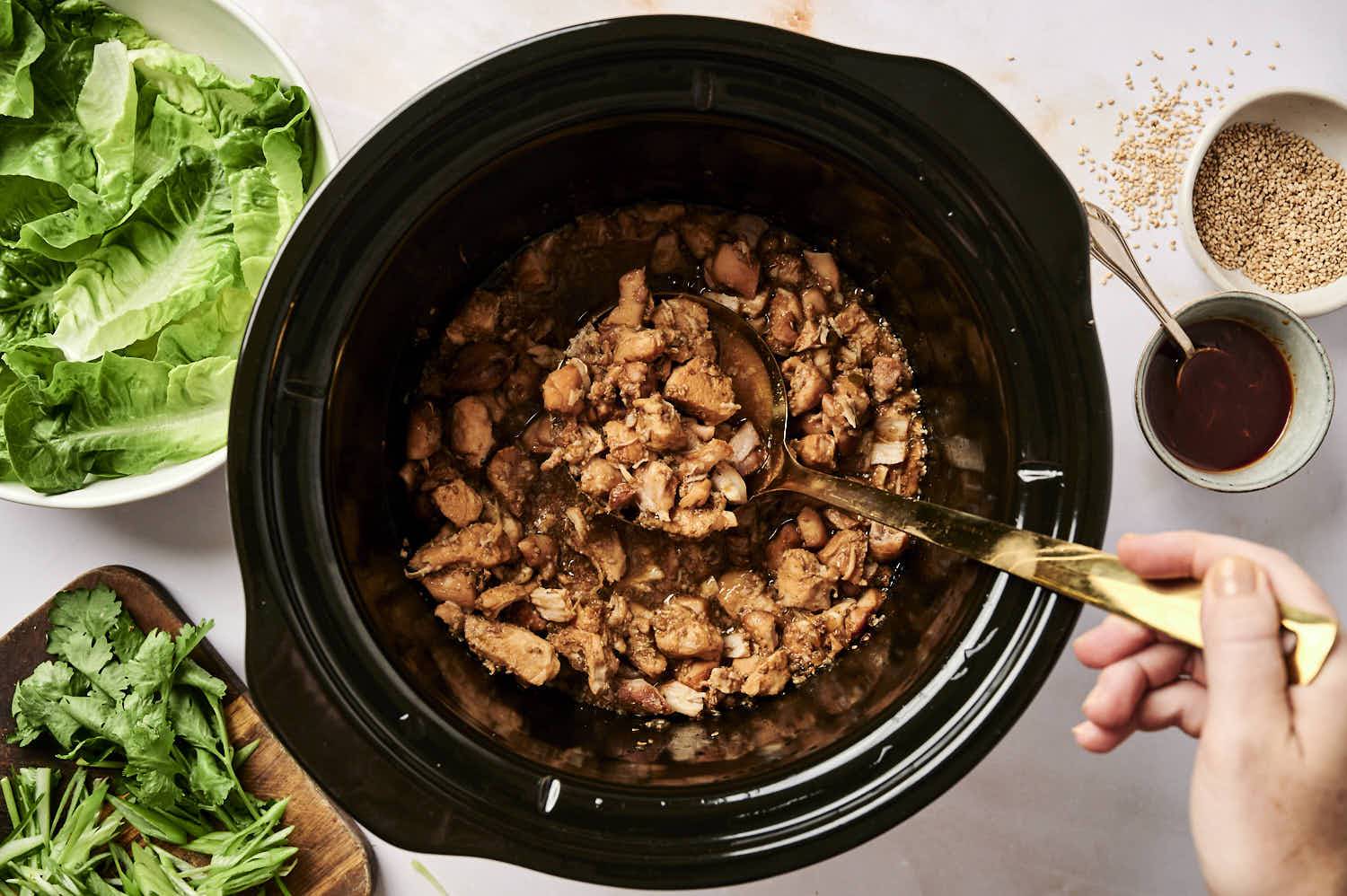 Crockpot Korean chicken in a slow cooker with sweet and spicy sauce.