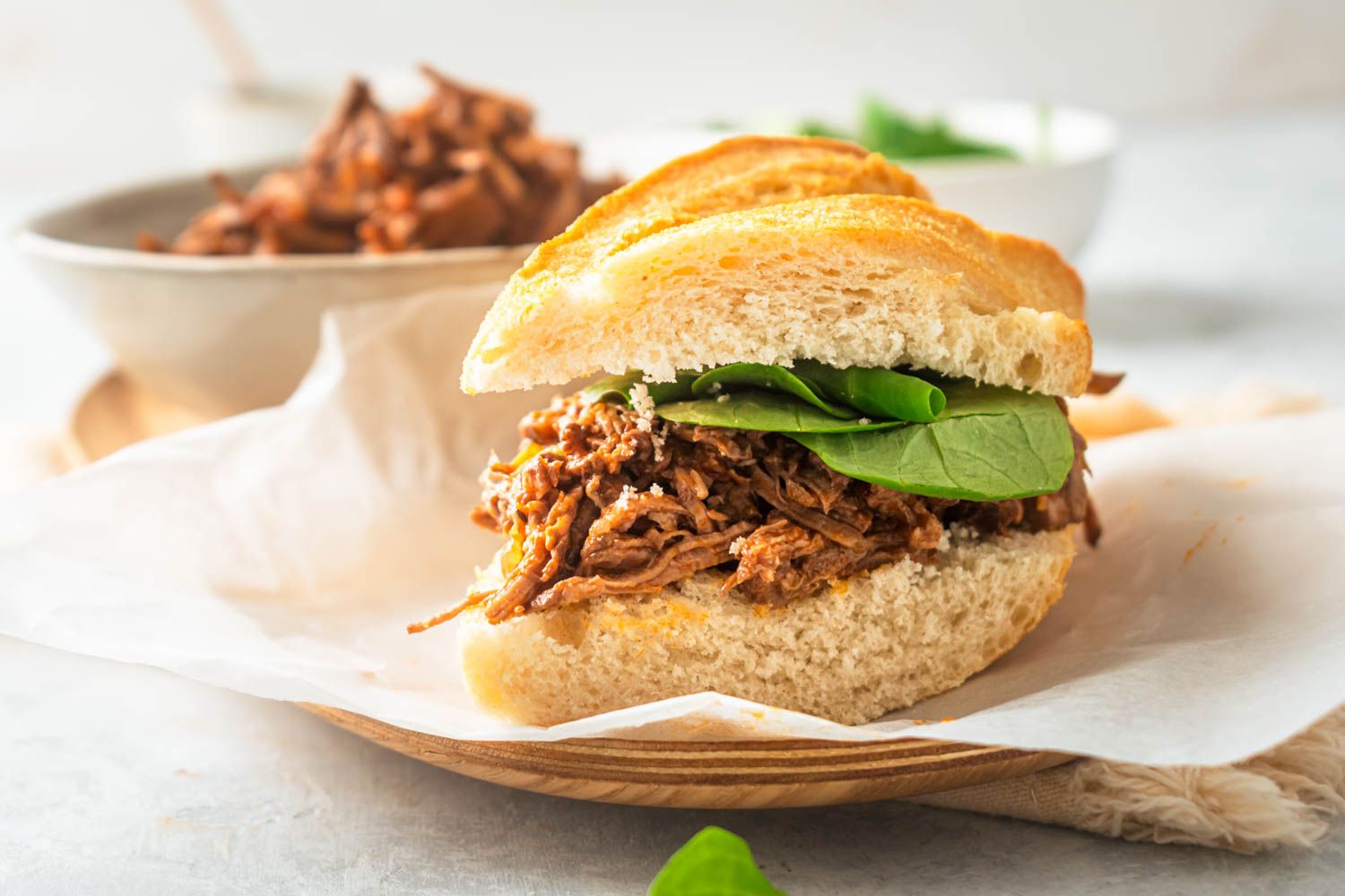Italian beef sandwich on two slices of bread with spinach.
