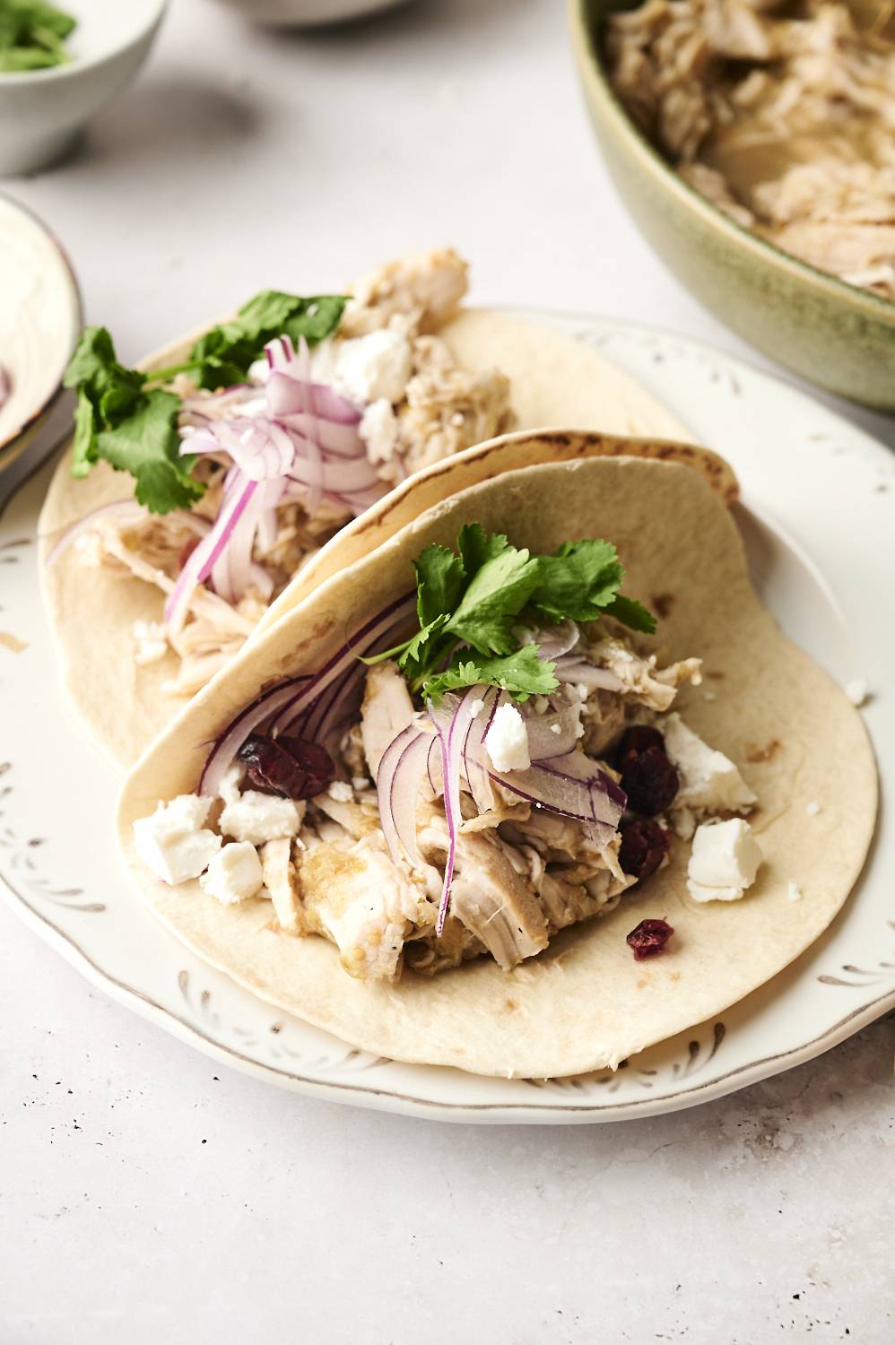Soft flour tortillas filled with shredded turkey, red onion, cilantro, dried cranberries, and crumbled cheese.