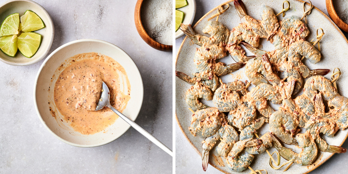A bowl of creamy marinade beside a plate of raw shrimp coated in the sauce, garnished with lime wedges and salt.