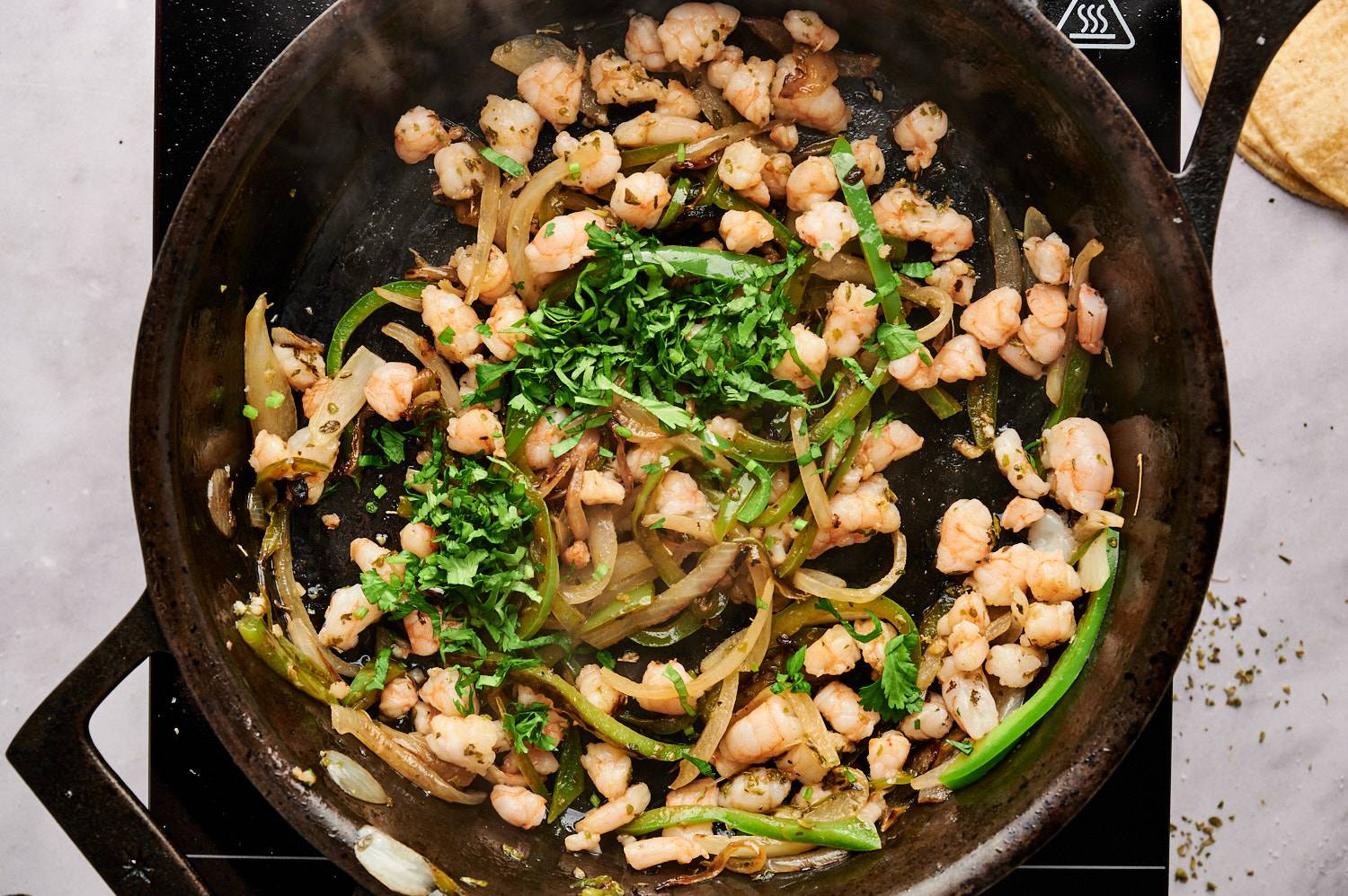 Sauteed shrimp with poblano peppers, onions, cilantro, oregano, garlic, salt, and pepper for taco filling.