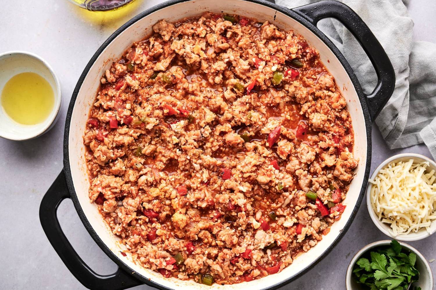 Ground taco turkey and cauliflower rice in tomato salsa in a large skillet.