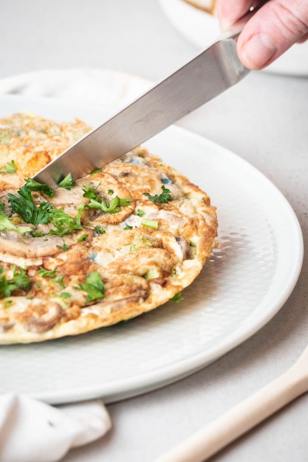 Hashbrown egg casserole being sliced with a nice.