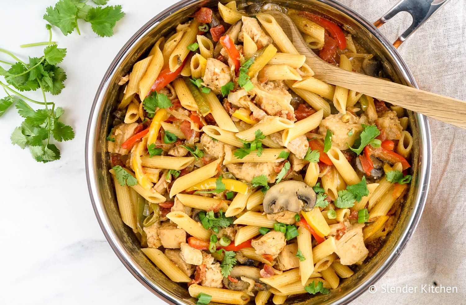 Healthy chicken fajita pasta with peppers, onions, and mushrooms.