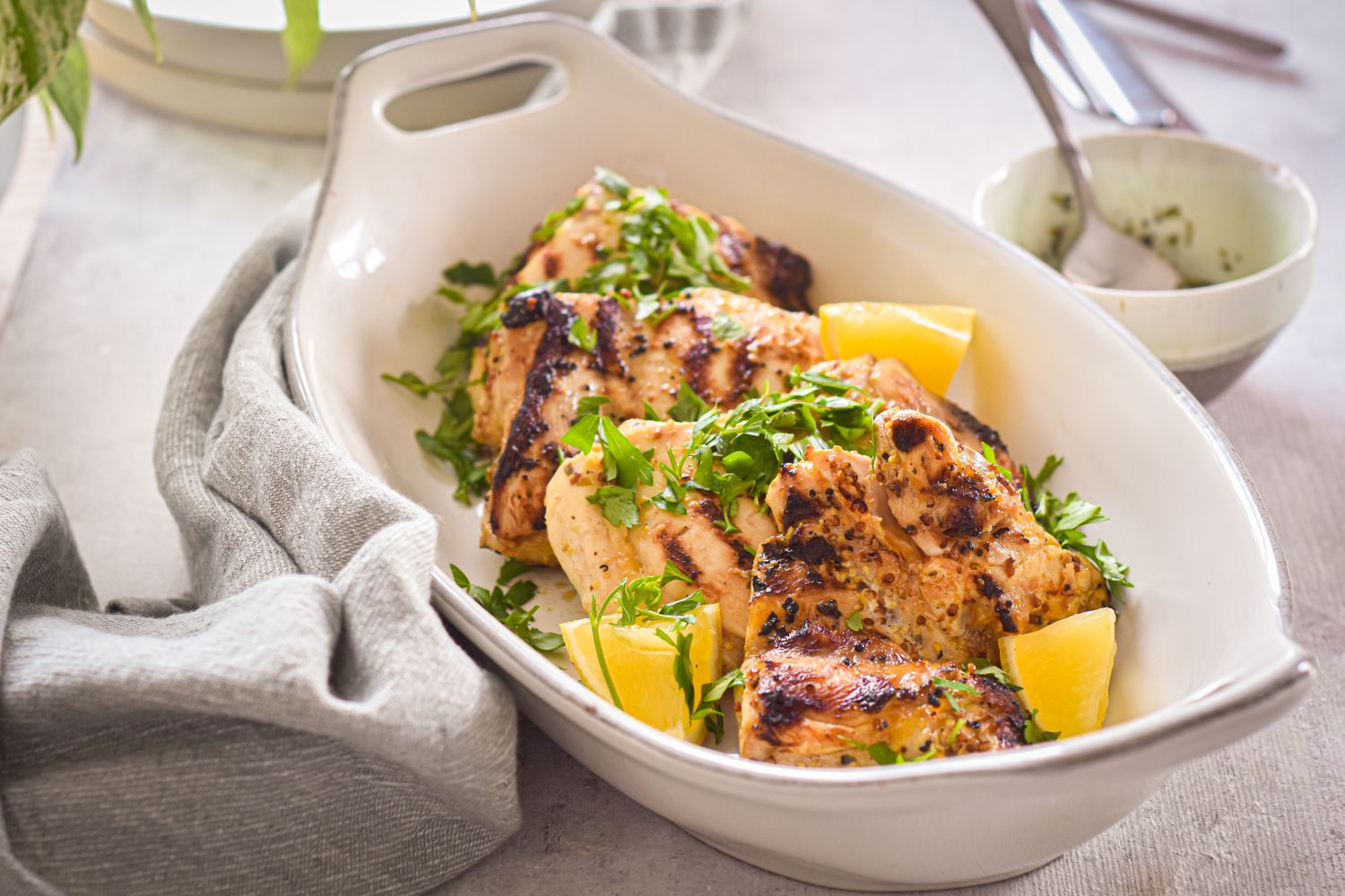 Grilled Lemon Dijon Chicken Thighs with fresh lemon slices and grill marks.