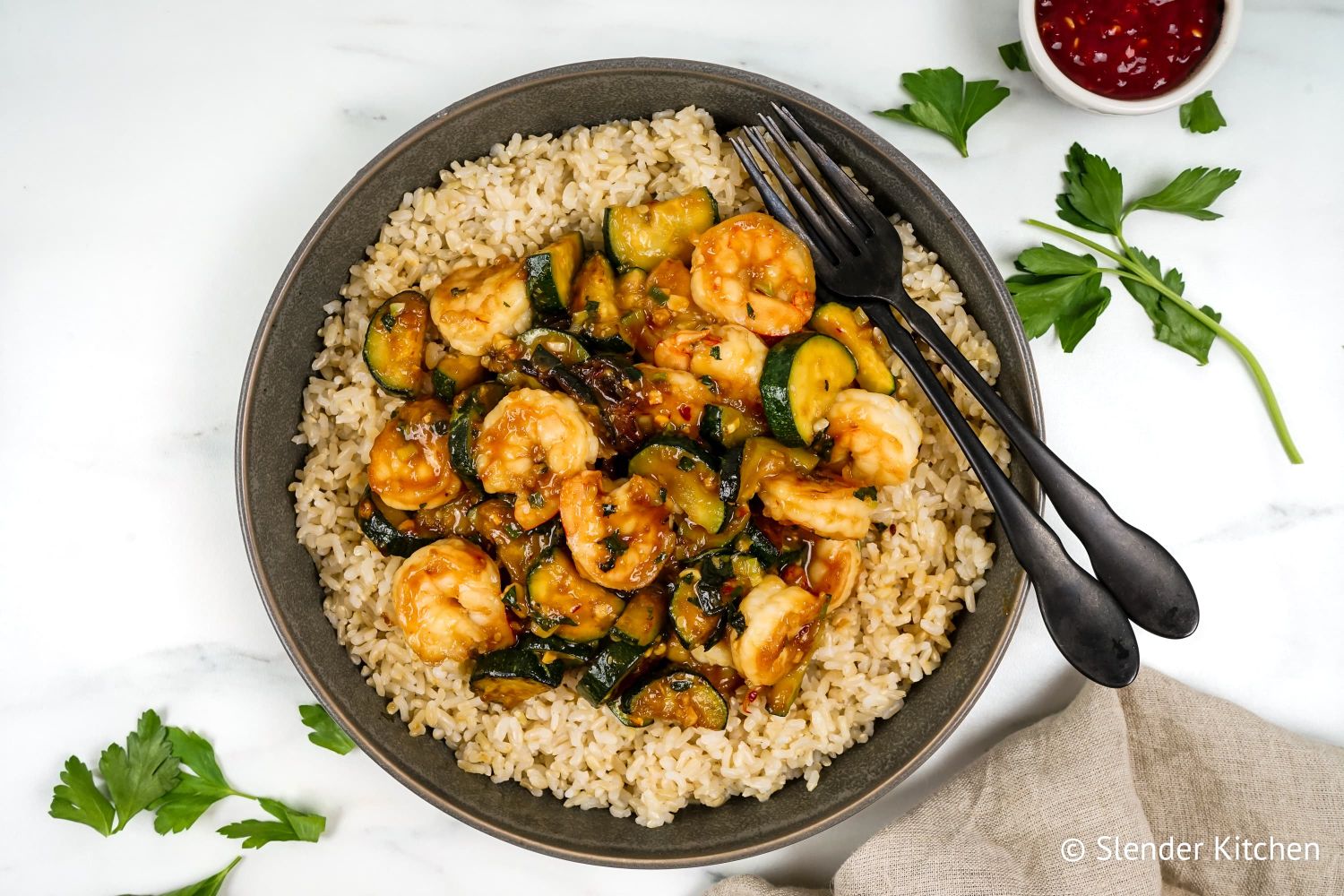 Stir fried shrimp with basil on a bed of brown rice.