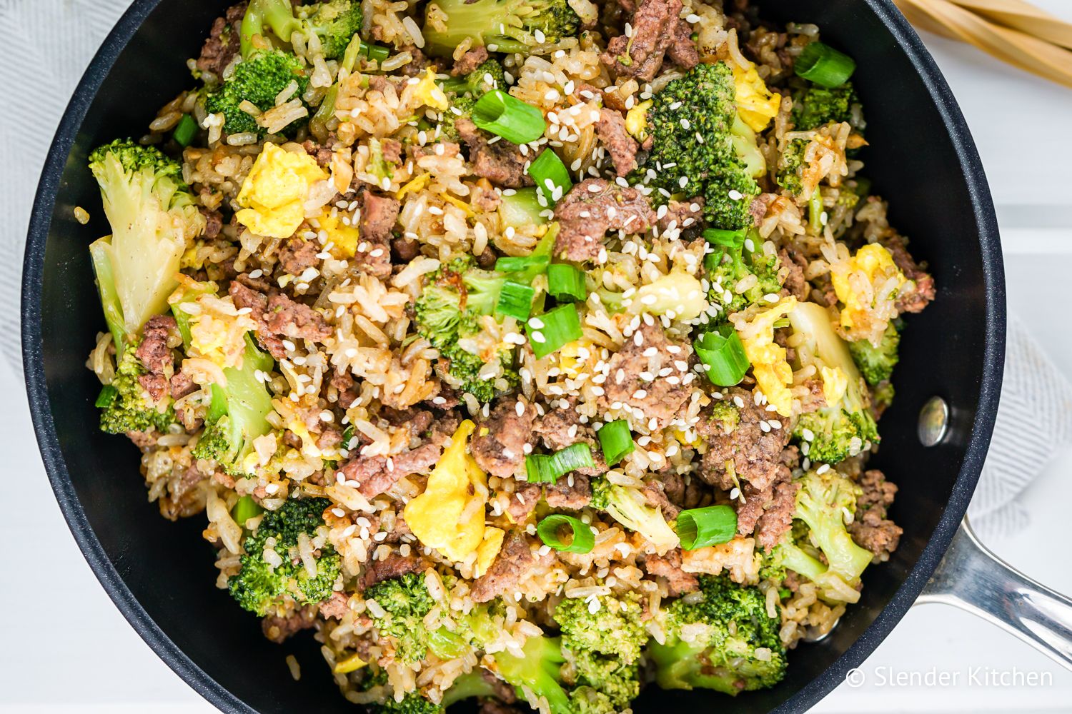 Beef and broccoli fried rice with eggs in a skillet.