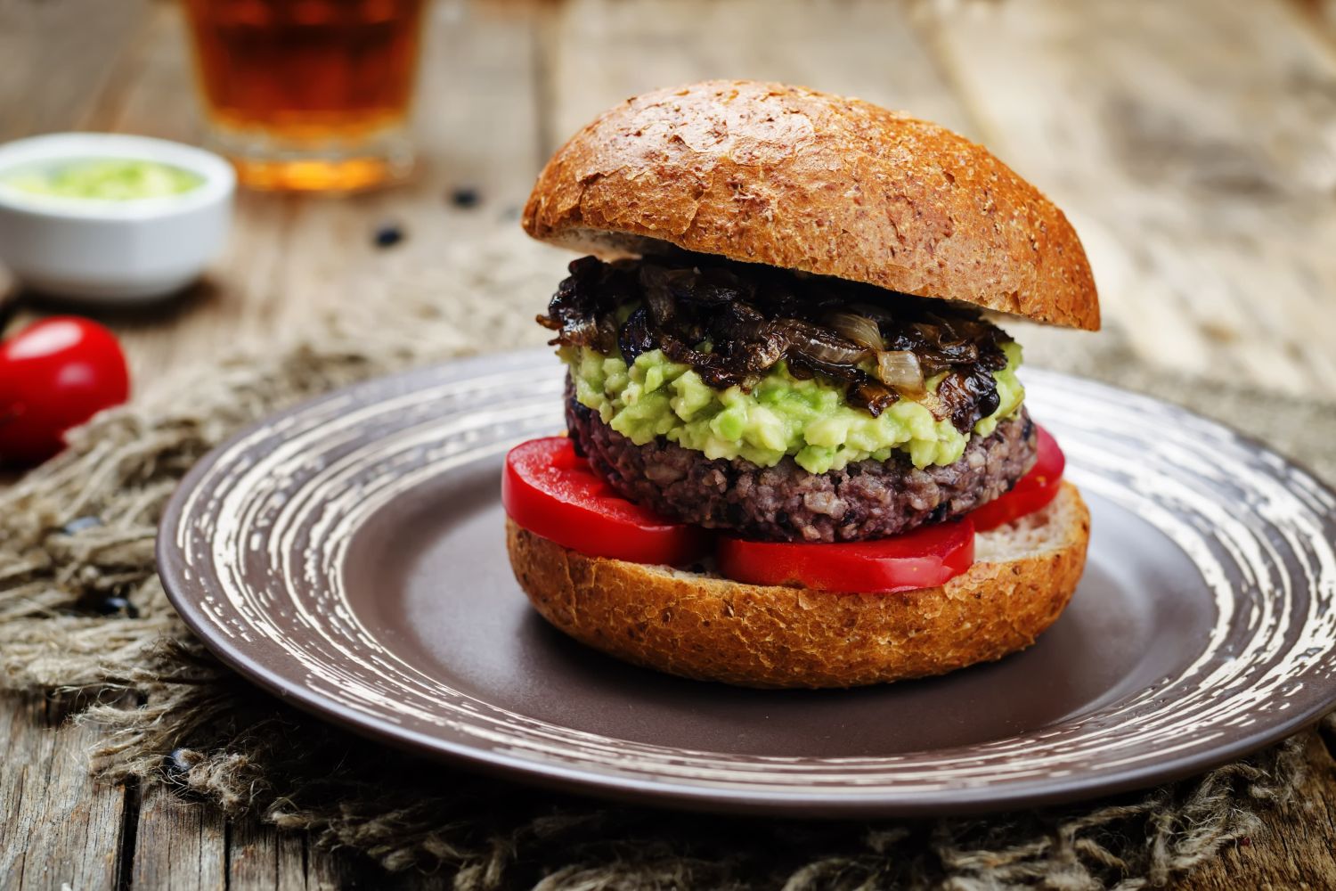 Salsa Black bean burgers with avocado, tomatoes, and onions on a bun. 