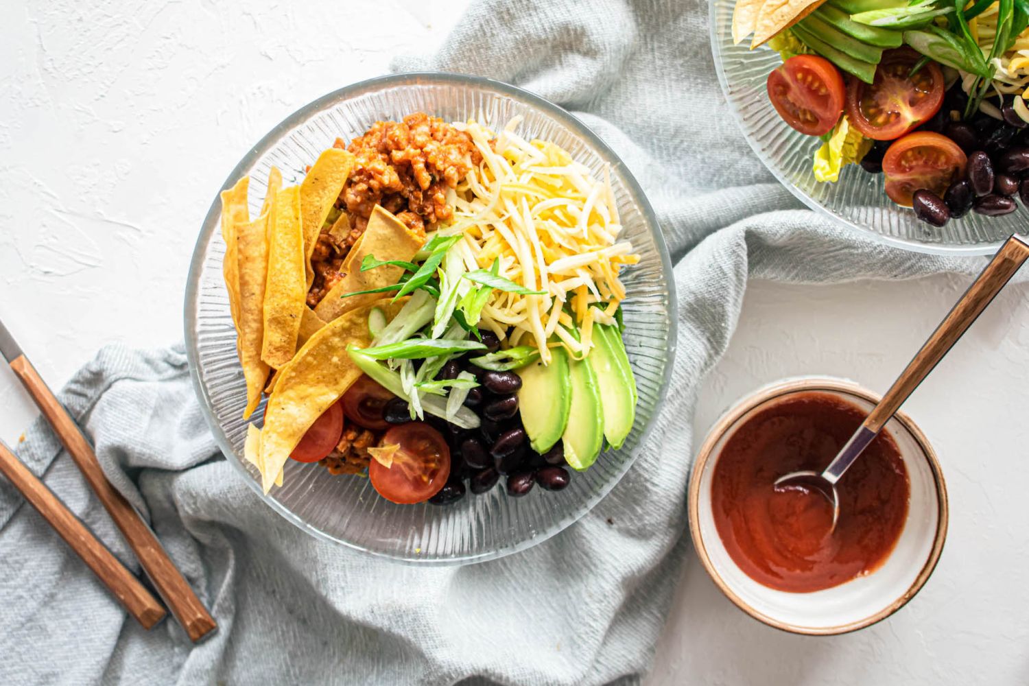 Turkey taco salad with ground turkey, tomatoes, black beans, cheddar cheese, and crispy tortilla strips.