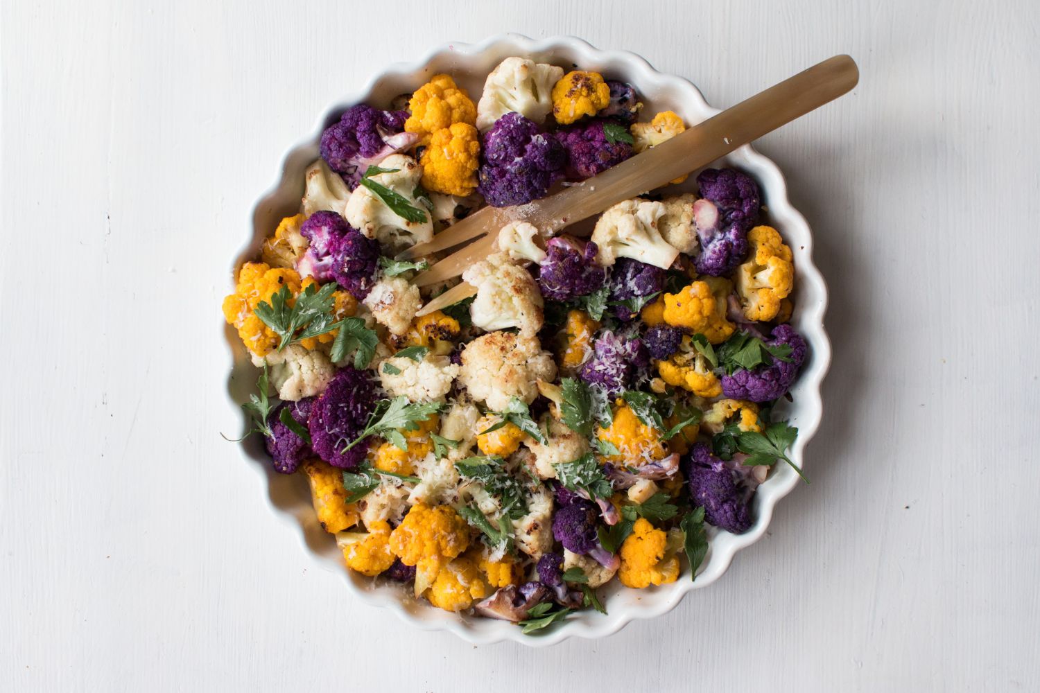Sauteed cauliflower with white, purple, and golden cauliflower florets with parmesan cheese and parsley.