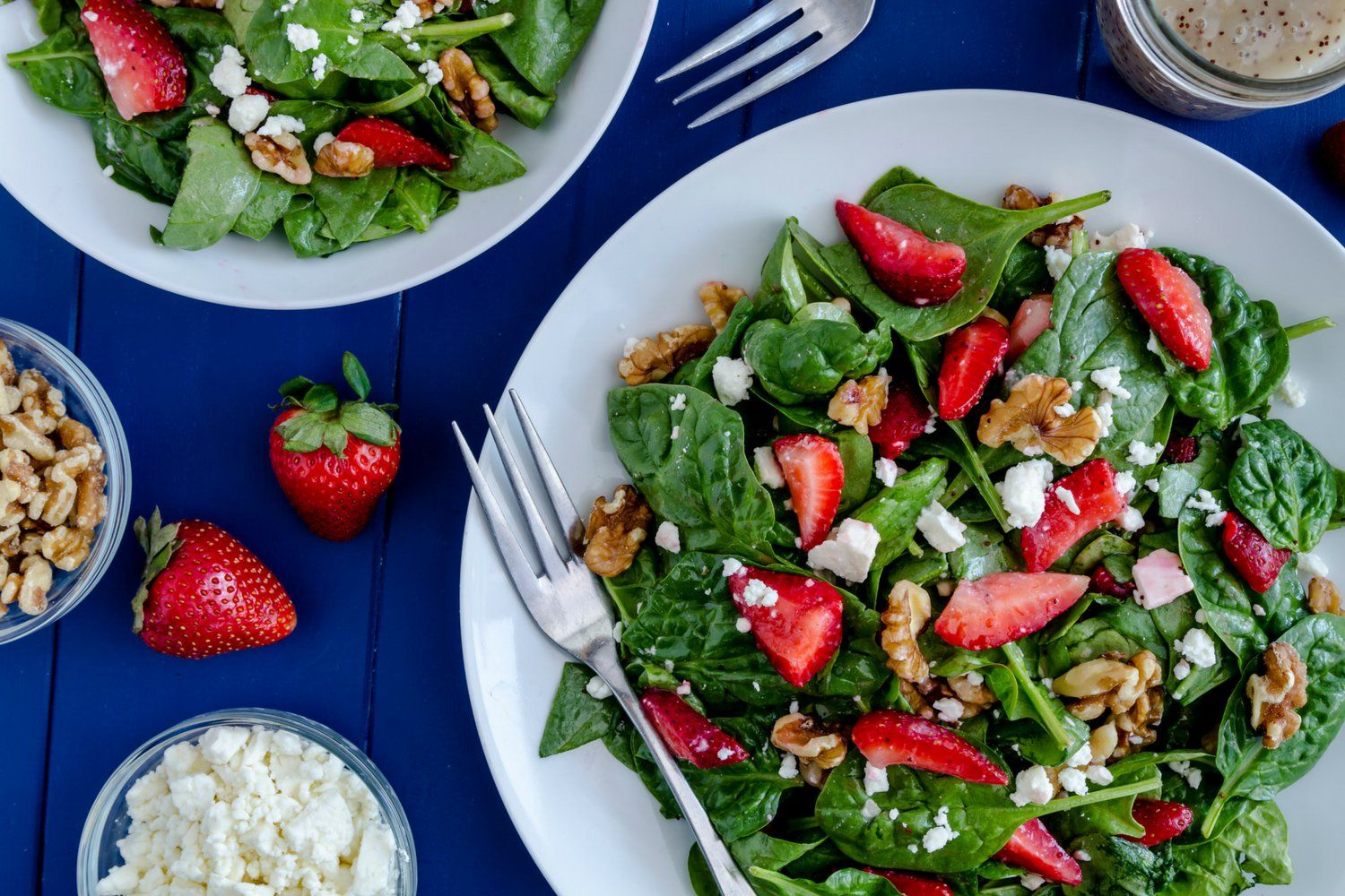 Strawberry spinach salad with poppyseed dressing, feta cheese, and walnuts.
