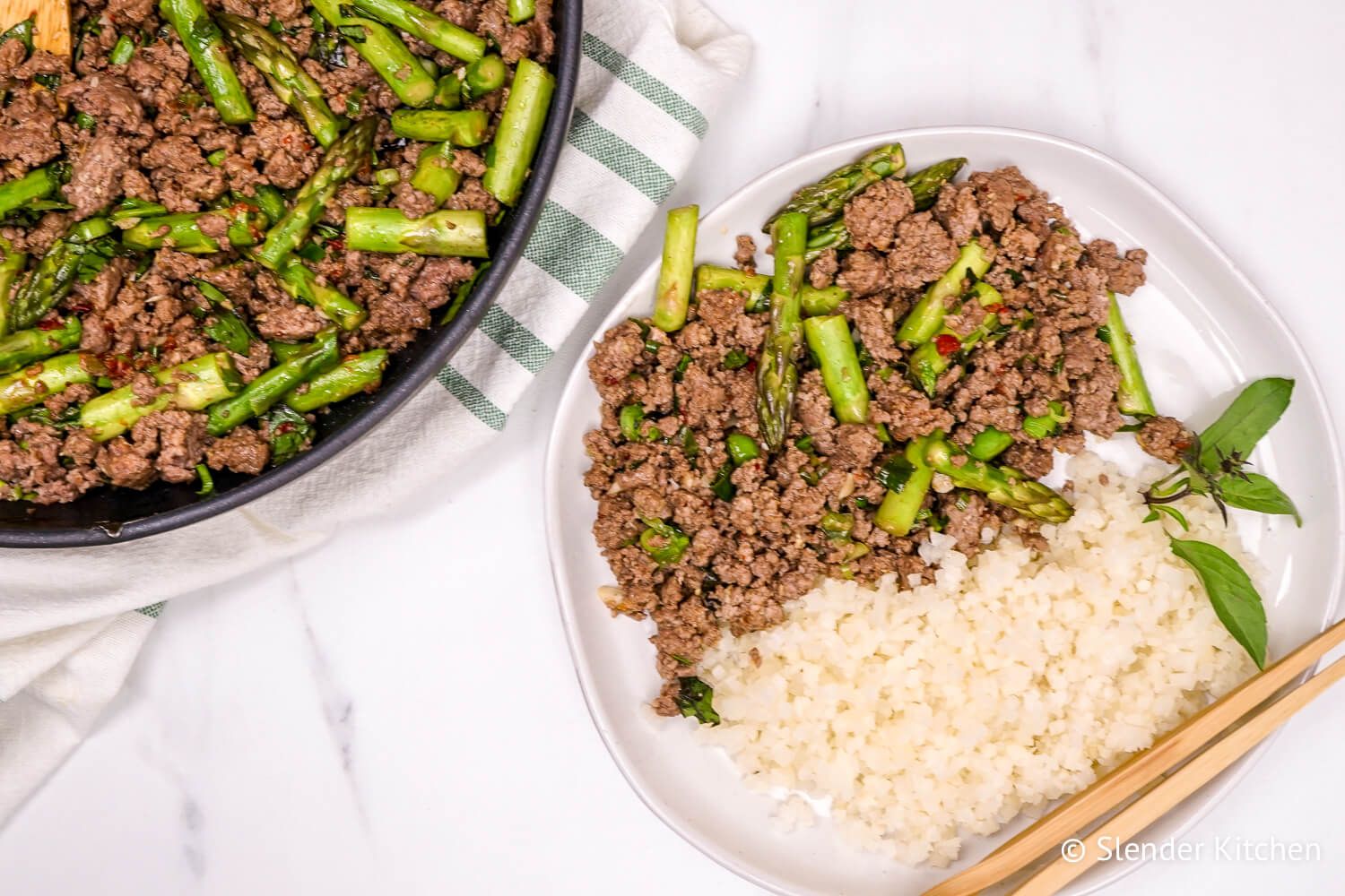 Thai Basil Ground Beef on a plate with rice and a skillet.