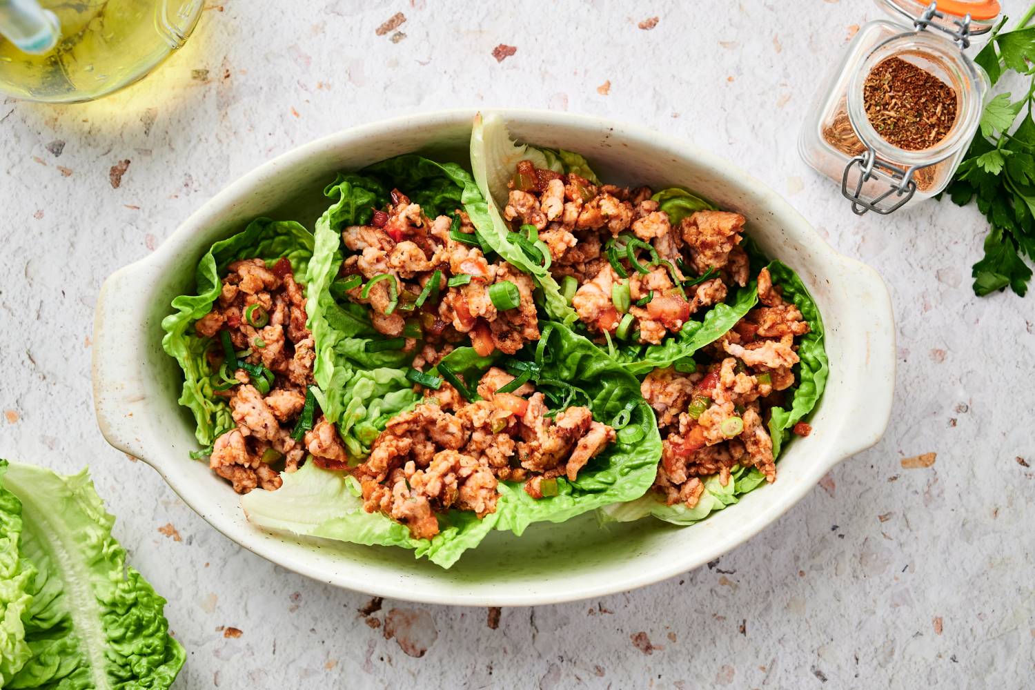 Turkey taco lettuce wraps with tomatoes, shredded cheese, ground turkey, and avocado. 
