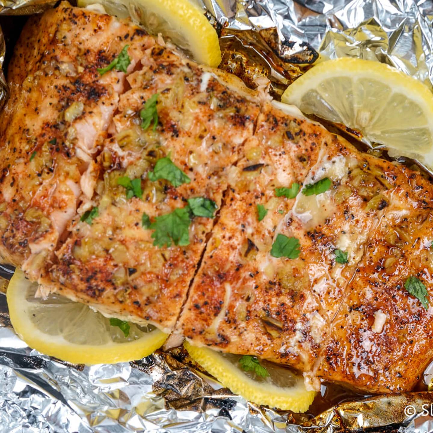 Baked Garlic Lemon Salmon wrapped in foil with honey and cilantro.