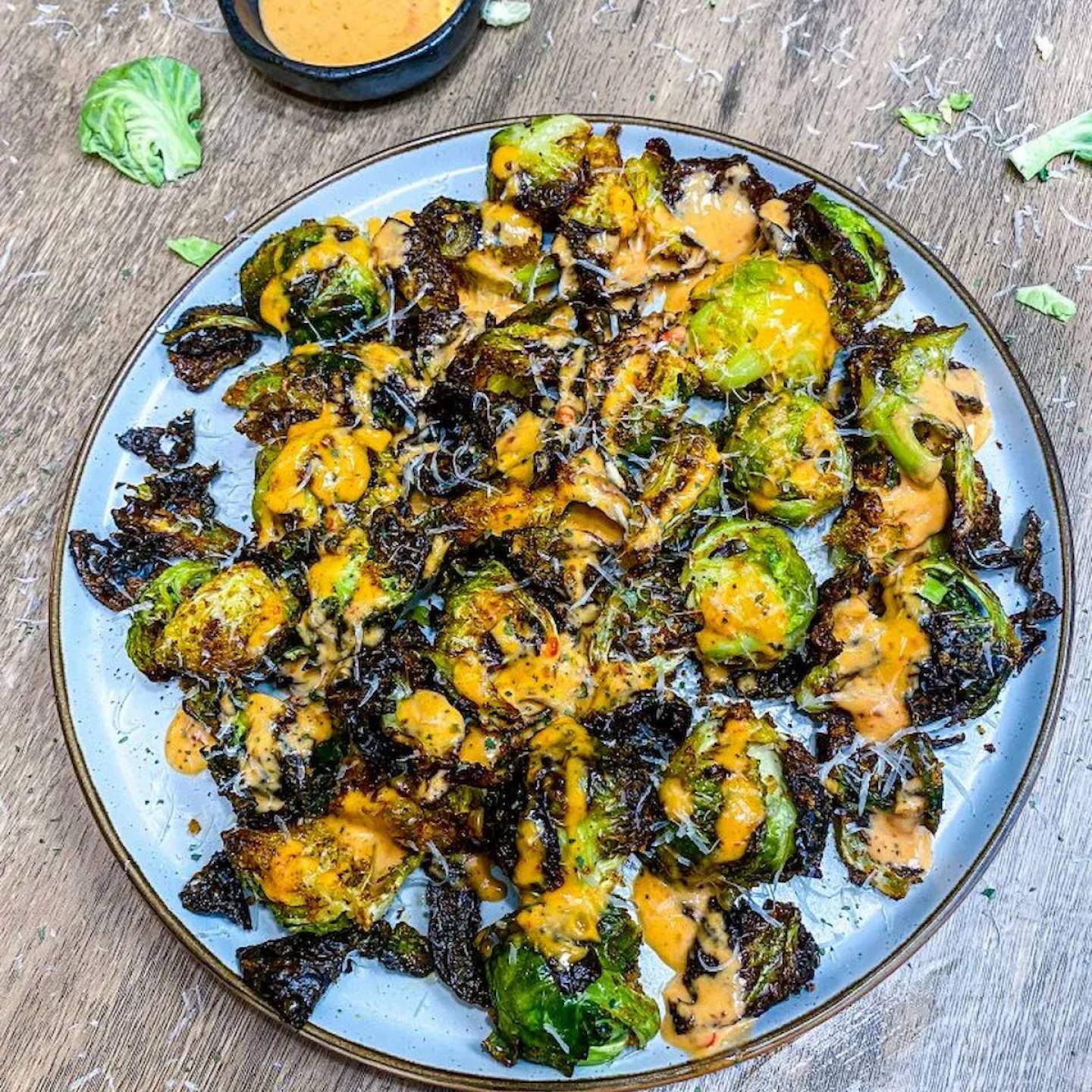 Air Fryer Bang Bang Brussels Sprouts with creamy spicy sauce.