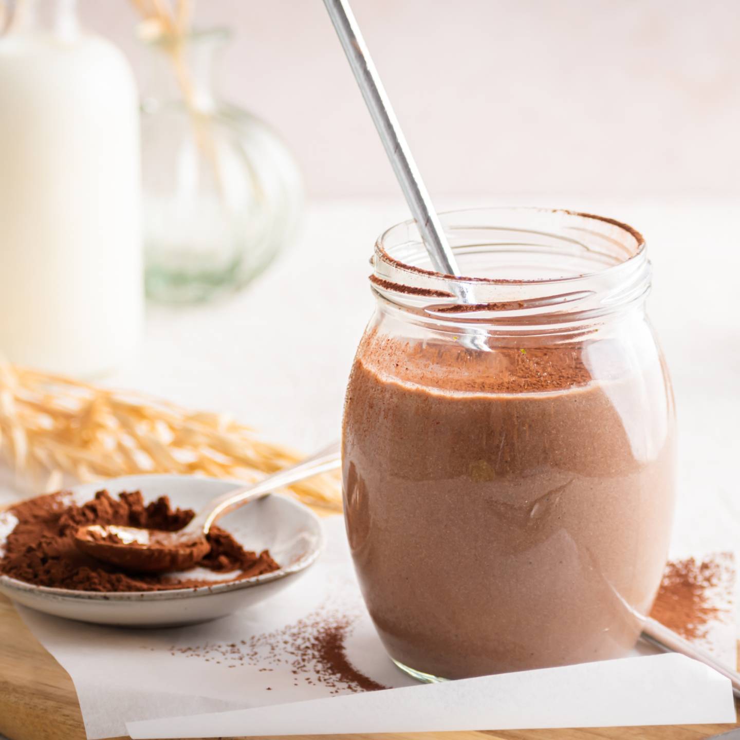 Chocolate breakfast shake with tofu, almond milk, and bananas in a mason jar with whipped cream.