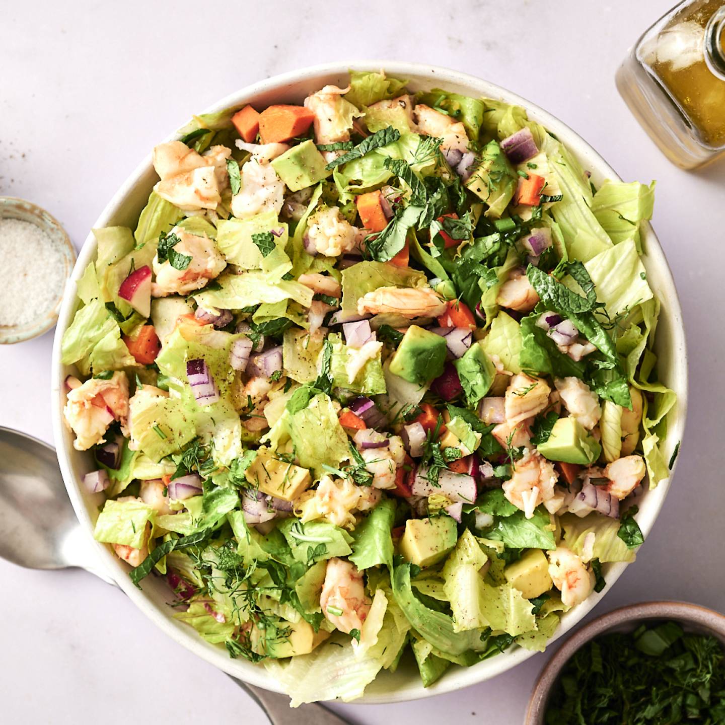 A top-down shot of a bowl of chopped shrimp salad, garnished with cilantro.