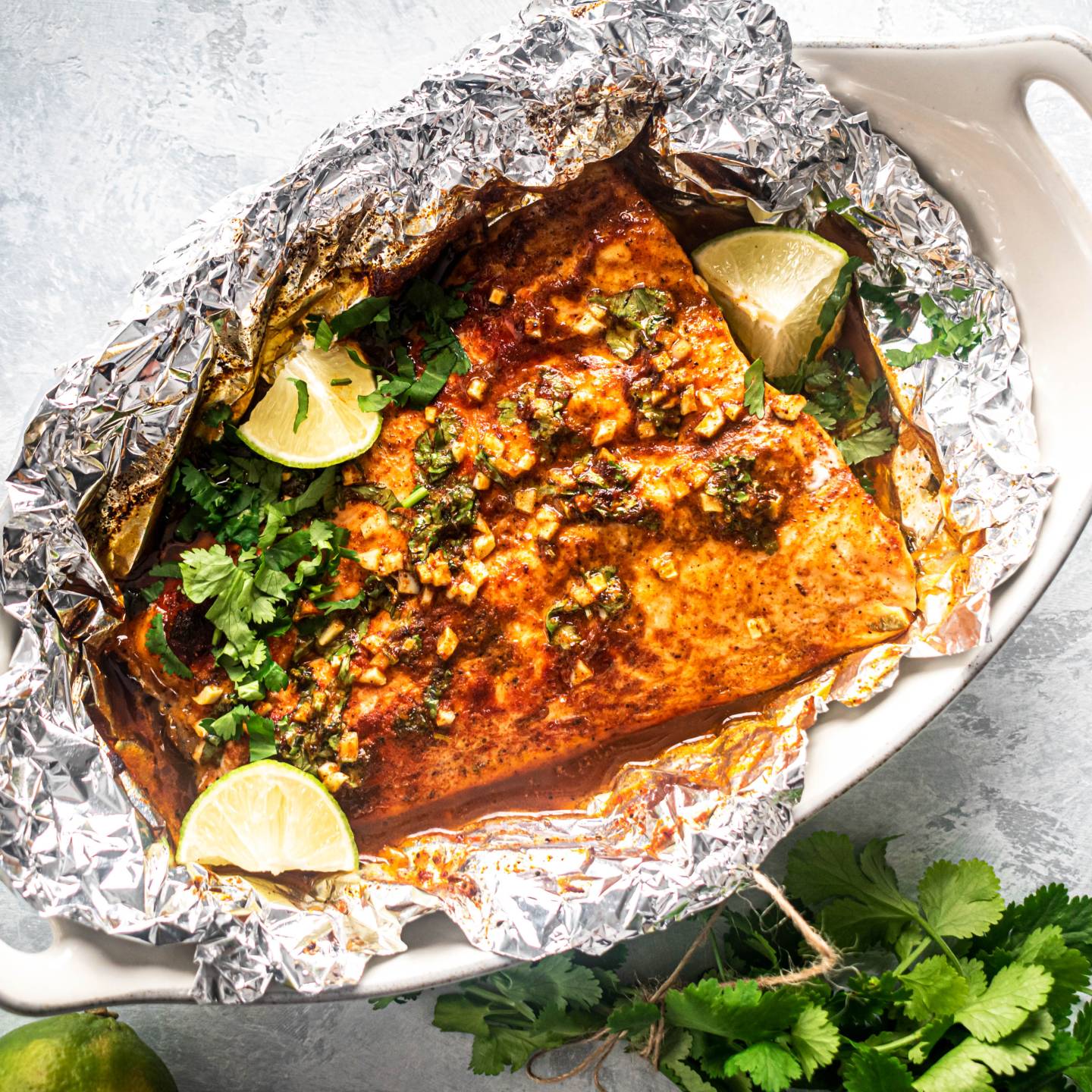 Cilantro lime salmon cooked in foil with garlic, lime juice, cilantro, and honey.