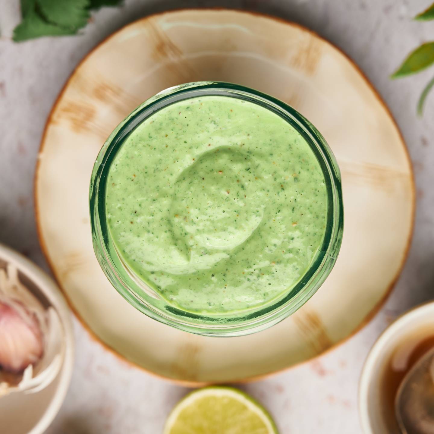 Cilantro lime sauce made with Greek yogurt, cilantro, garlic, lime juice, and spices in a glass jar. 