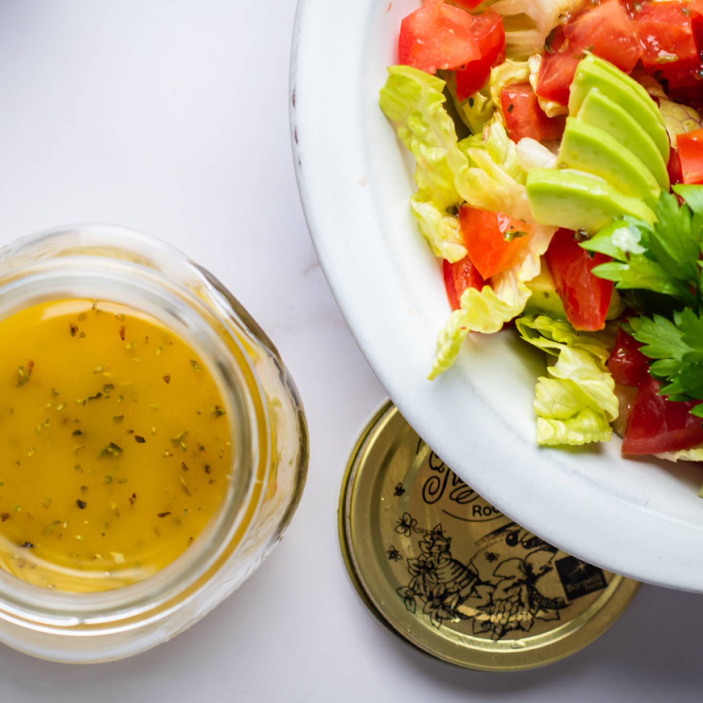 Light Italian dressing in a jar with olive oil, vinegar, and lemon and served over a green salad.