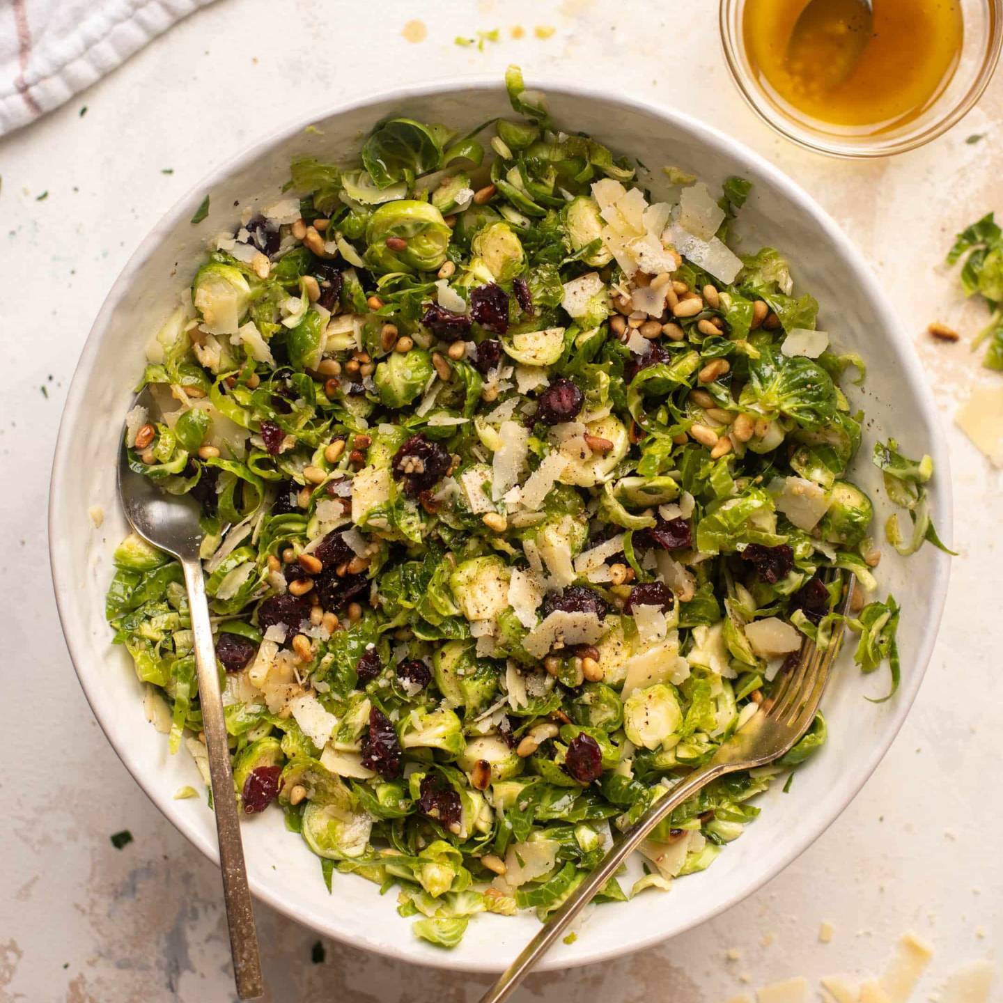 Spiced maple brussels sprouts salad with cranberries and nuts in a bowl.