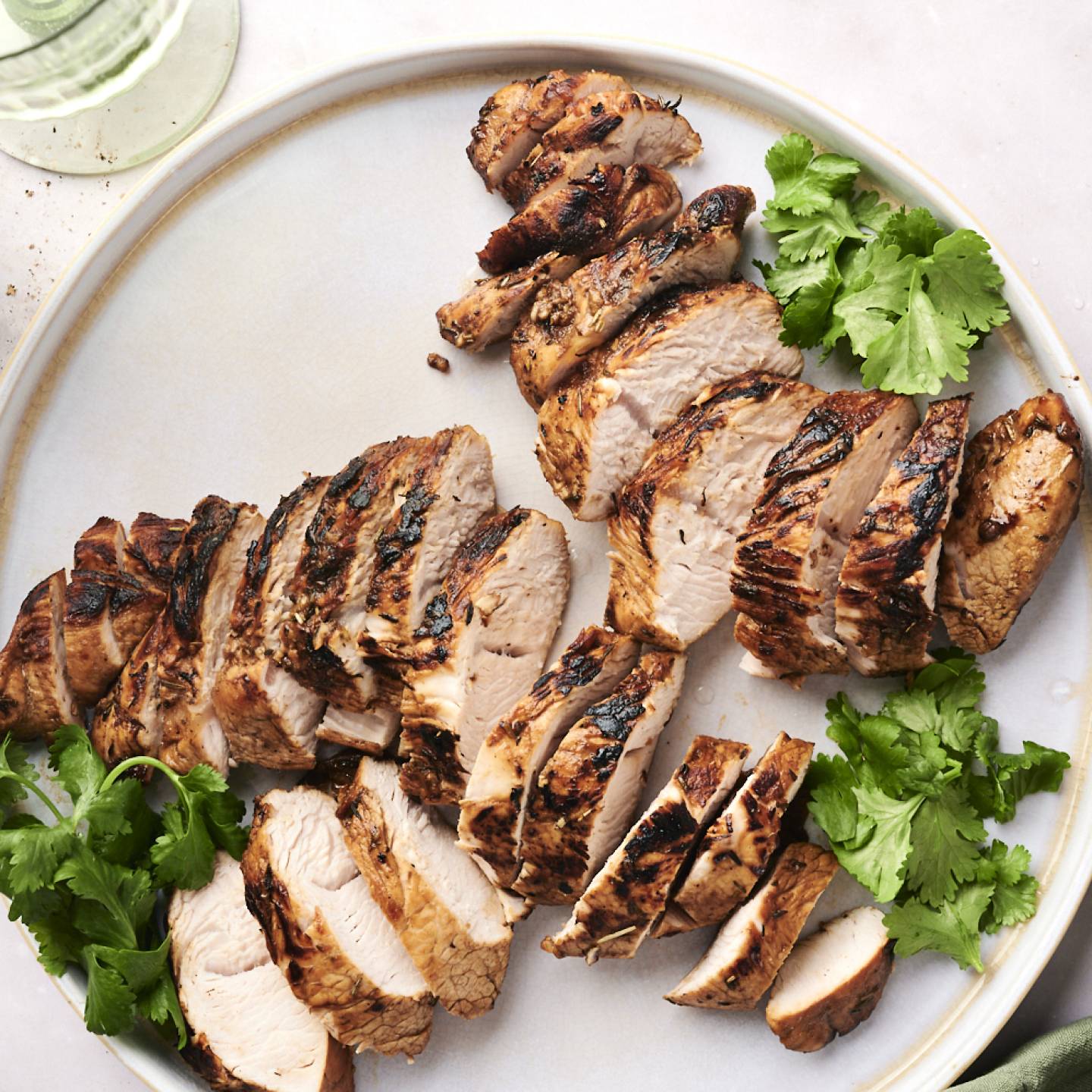 Pan seared turkey tenderloin sitting on a plate. 