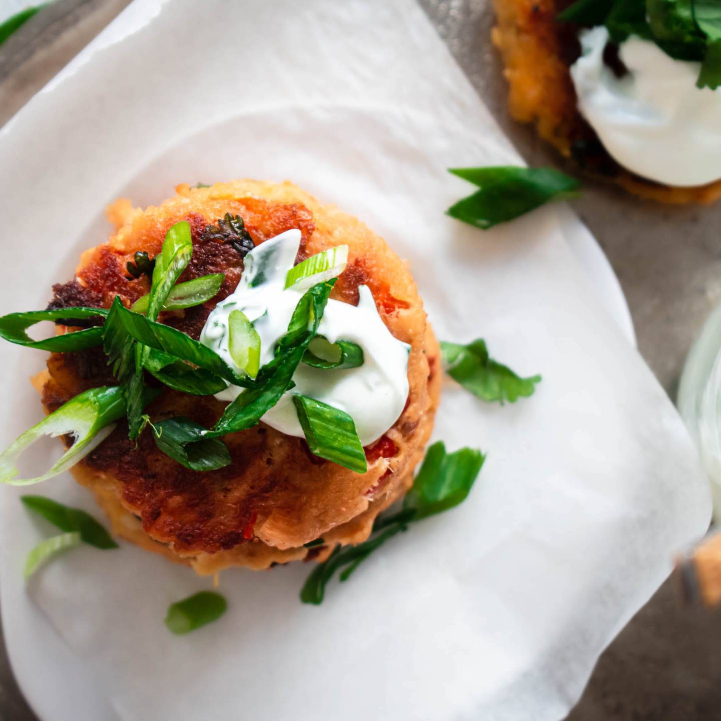 Salmon patties made with canned salmon, fresh herbs, breadcrumbs, and bell peppers cooked until golden brown.