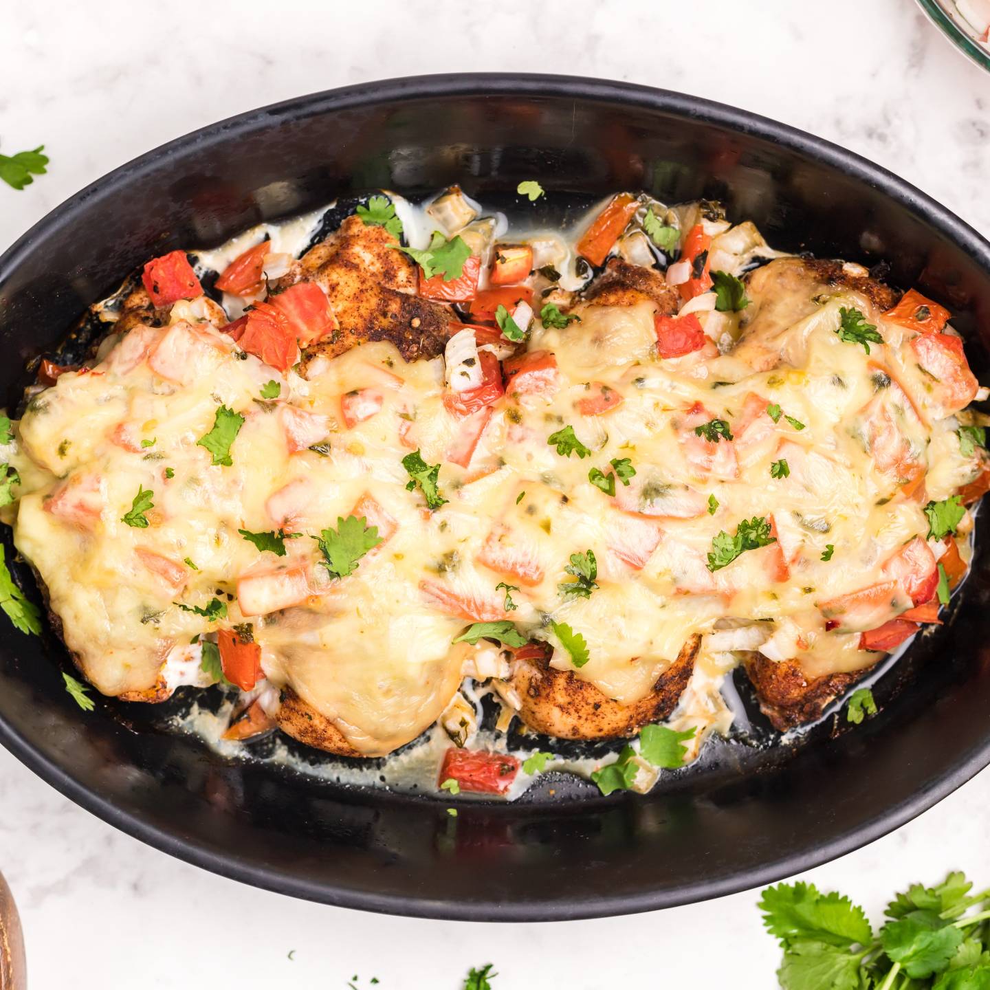 Salsa chicken with pico de gallo salsa, melted cheese, and cilantro.