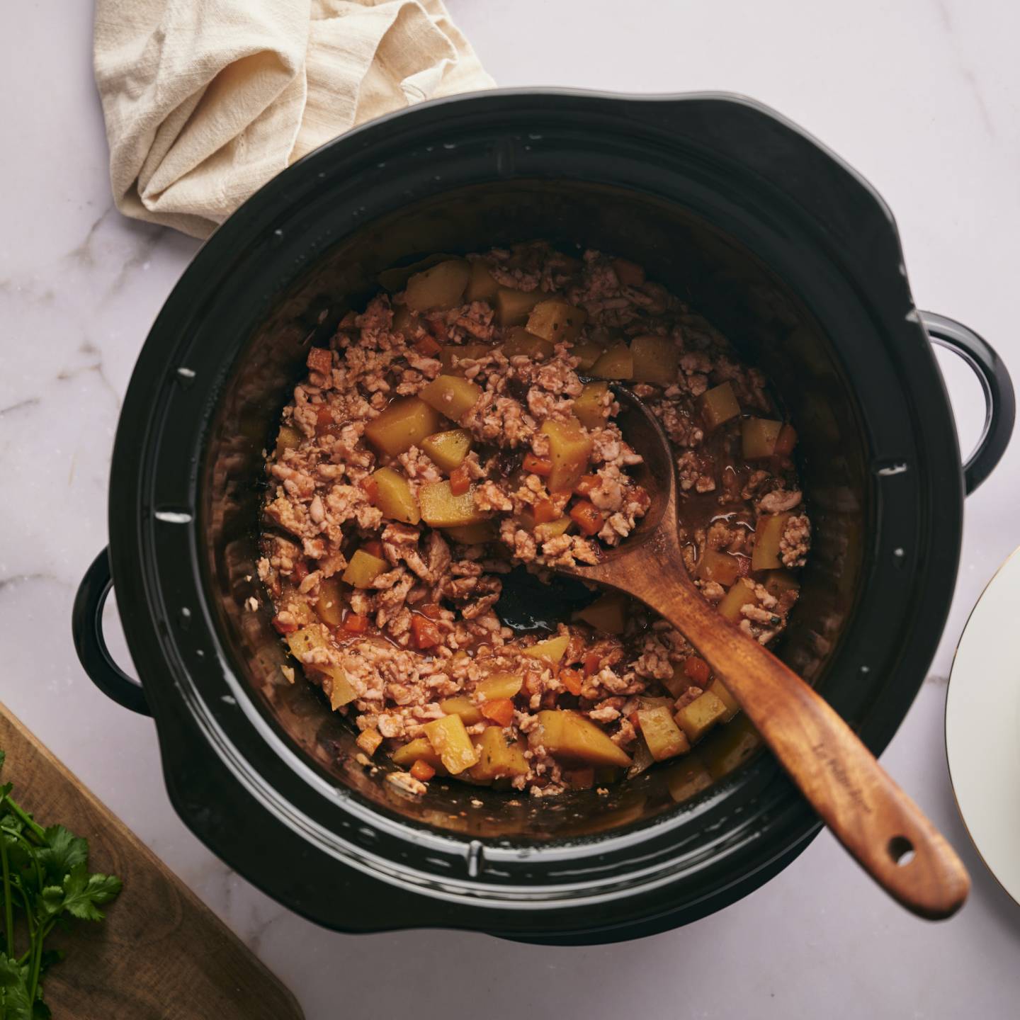Slow cooker picadillo with ground meat, potatoes, and carrots with a spicy tomato sauce. 