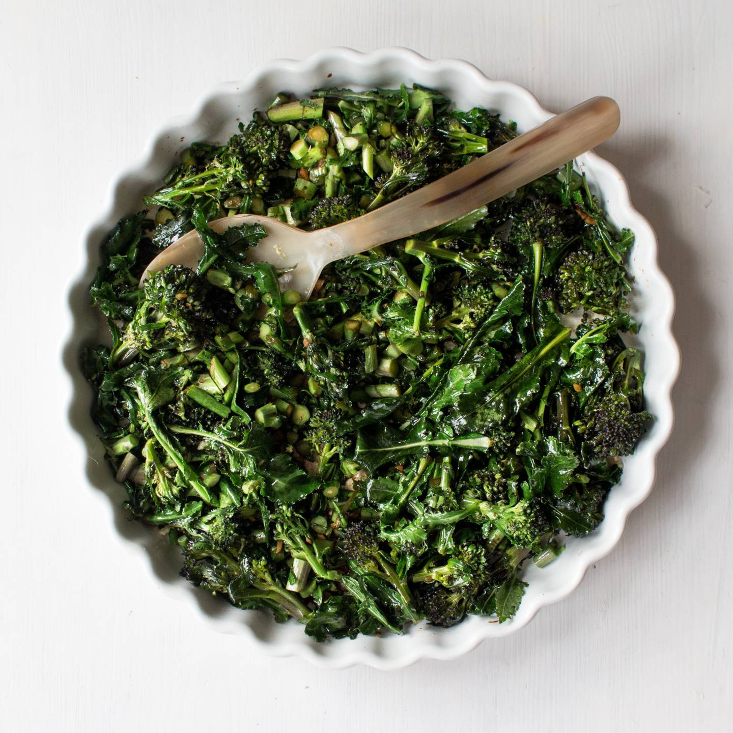 Asian broccolini chopped and cooked with garlic, ginger, and oyster sauce in a dish.