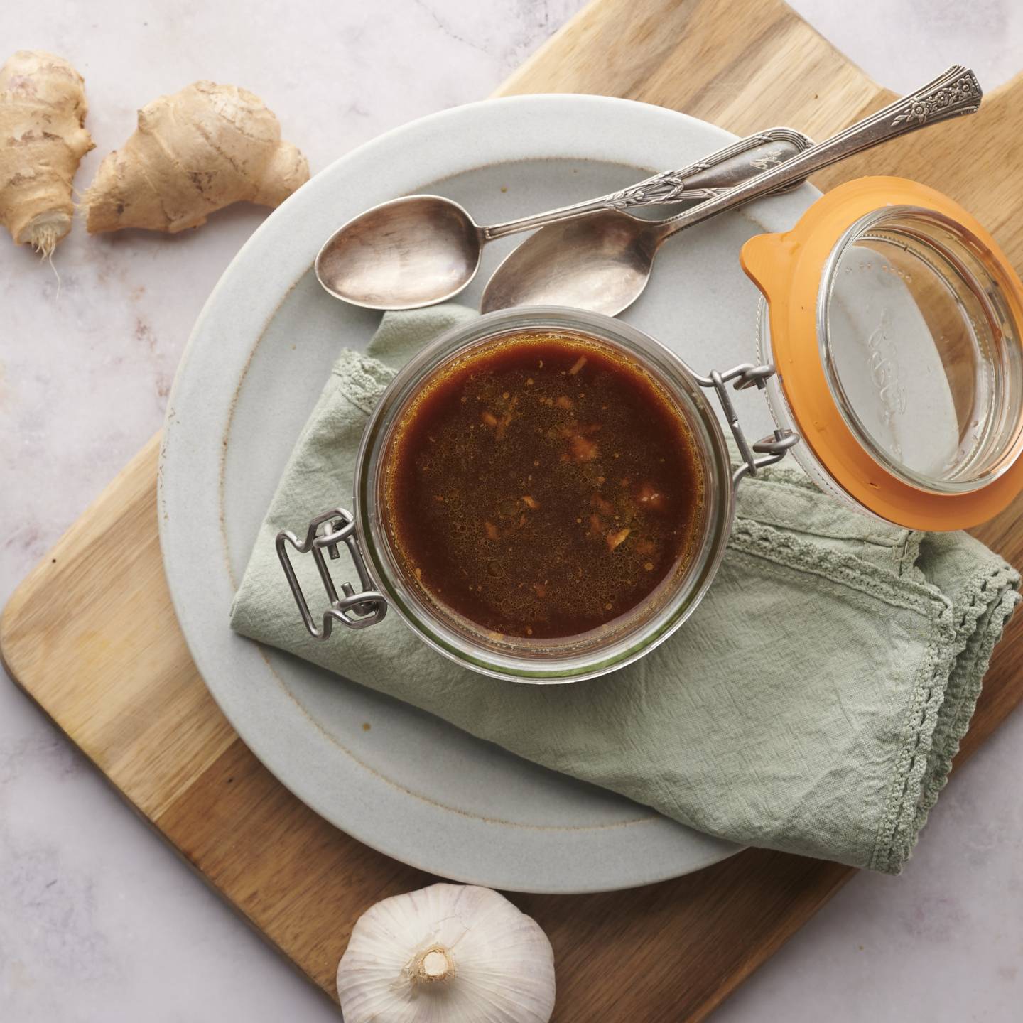Stir fry sauce made with soy sauce, honey, rice vinegar, garlic, ginger, and cornstarch in a jar.