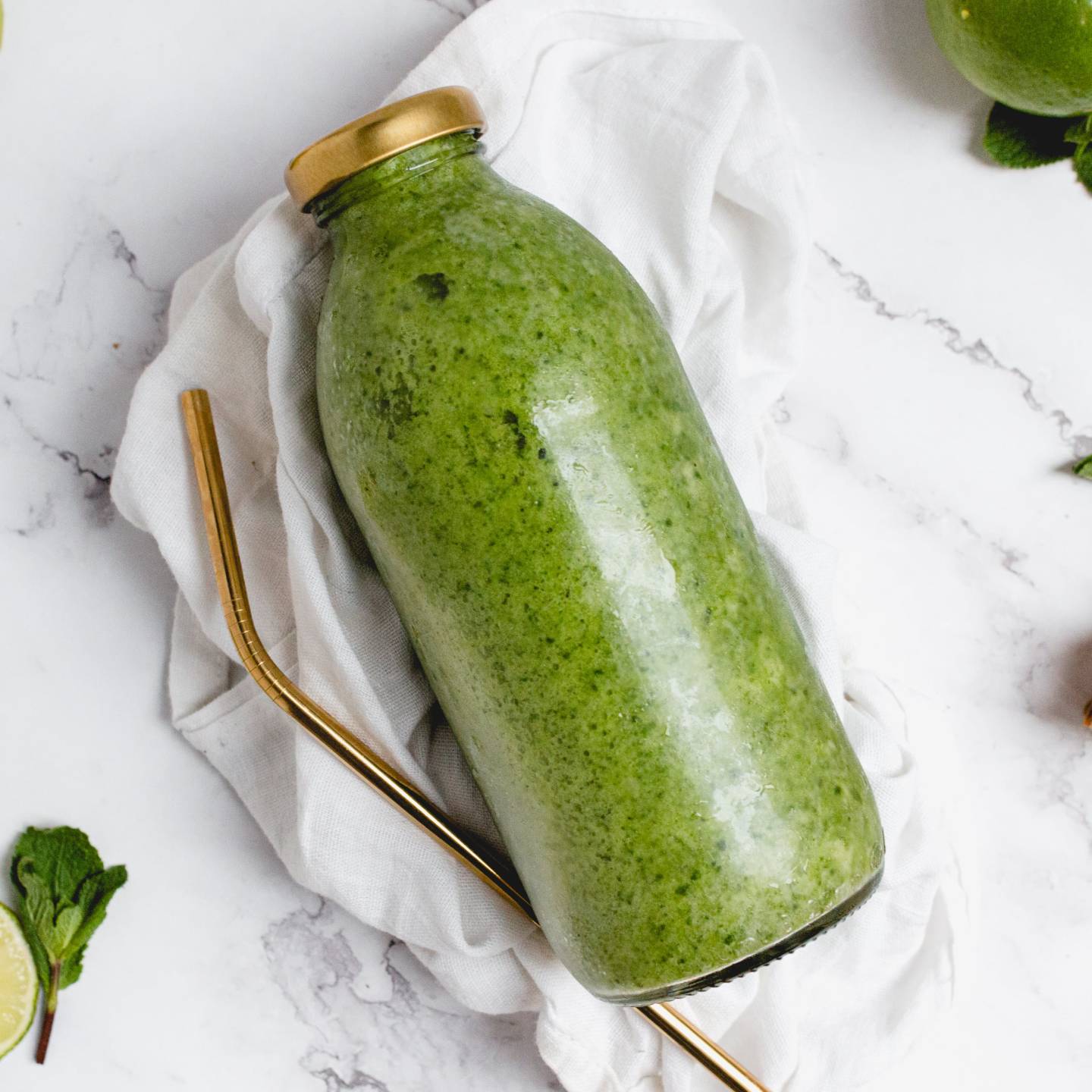 Tropical Mojito Pineapple Smoothie with mint and lime juice in a glass jar.