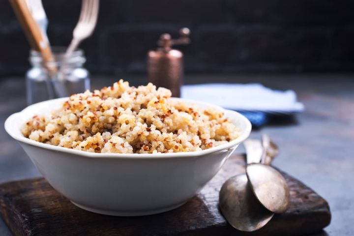 Ultimate guide to quinoa with a picture of cooked quinoa in a bowl.