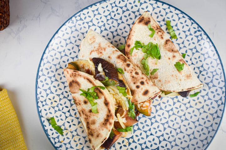 BBQ Portobello mushroom quesadillas with zucchini, red onions, mozzarella cheese, and barbecue sauce in a crispy tortilla.