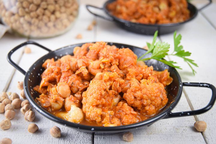 Slow cooker chickpea masala with cauliflower in tomato sauce with Indian spices and cilantro.