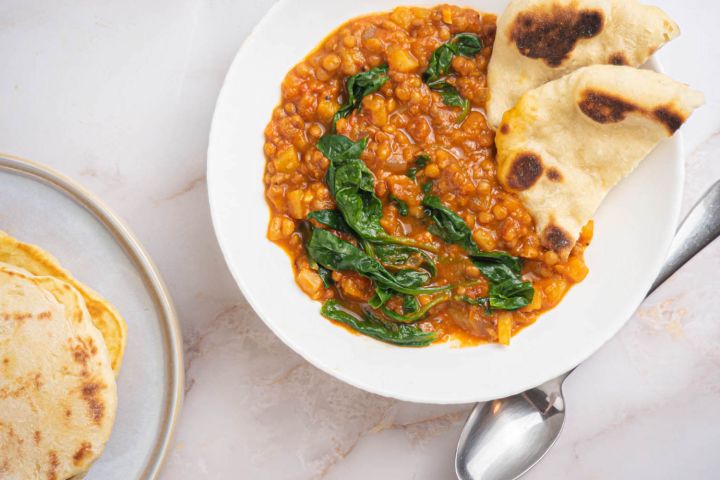 Slow cooker Madras Lentils with lentils, potatoes, and spinach in a creamy coconut sauce.